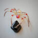 Handmade gold and red beaded spider ornament with faceted crystal body, metallic gold wire legs, and fiery glass bead accents 